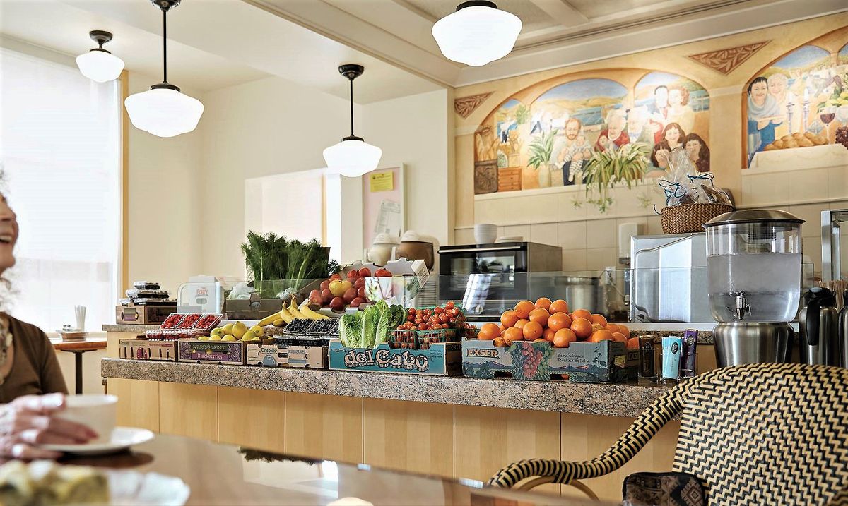 A grocery store counter displaying fresh fruits and vegetables.