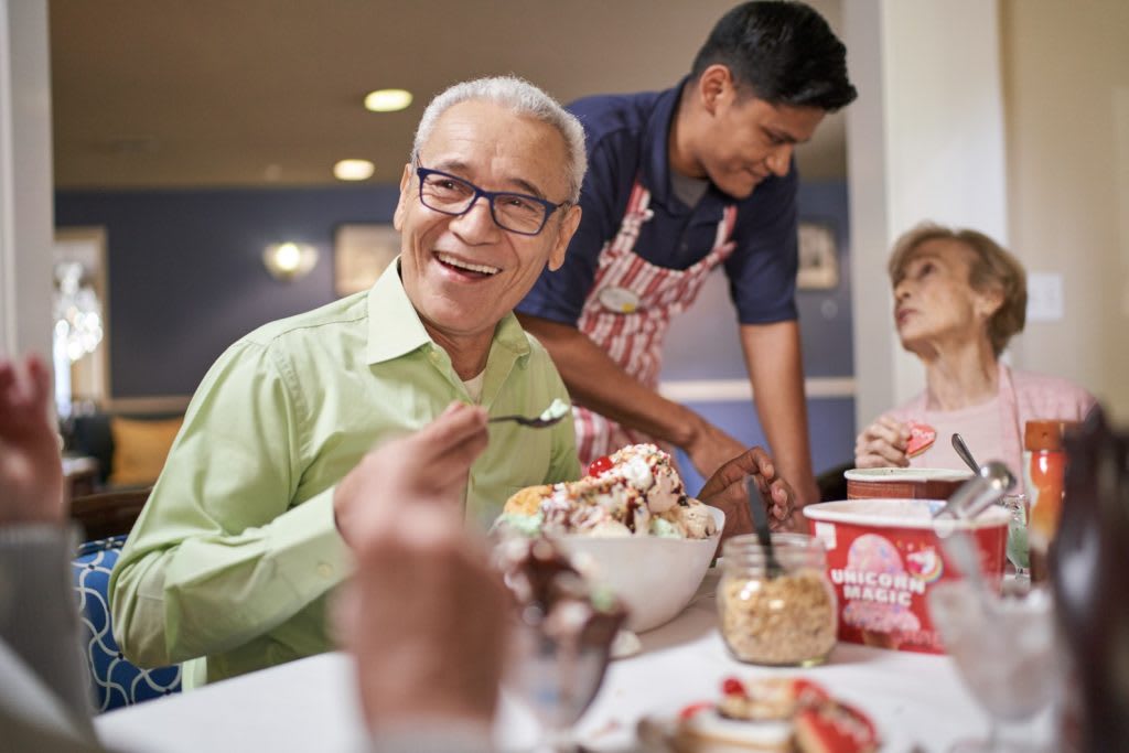 A group of people enjoying ice cream together at a restaurant.