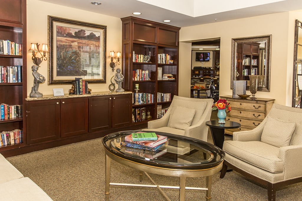 A cozy living room with a bookshelf and comfortable seating area.