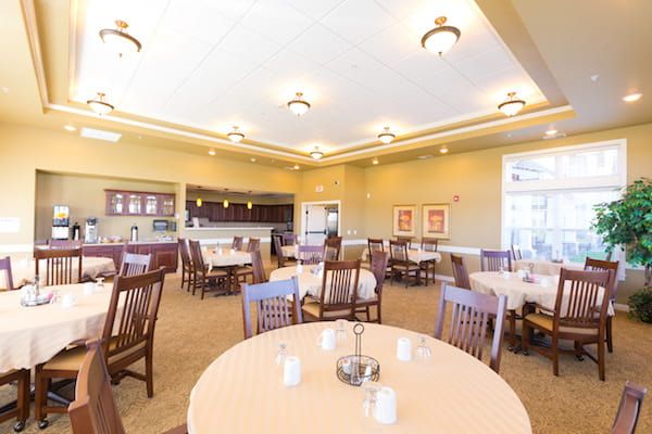 Interior view of a spacious dining room with neatly arranged tables and chairs.