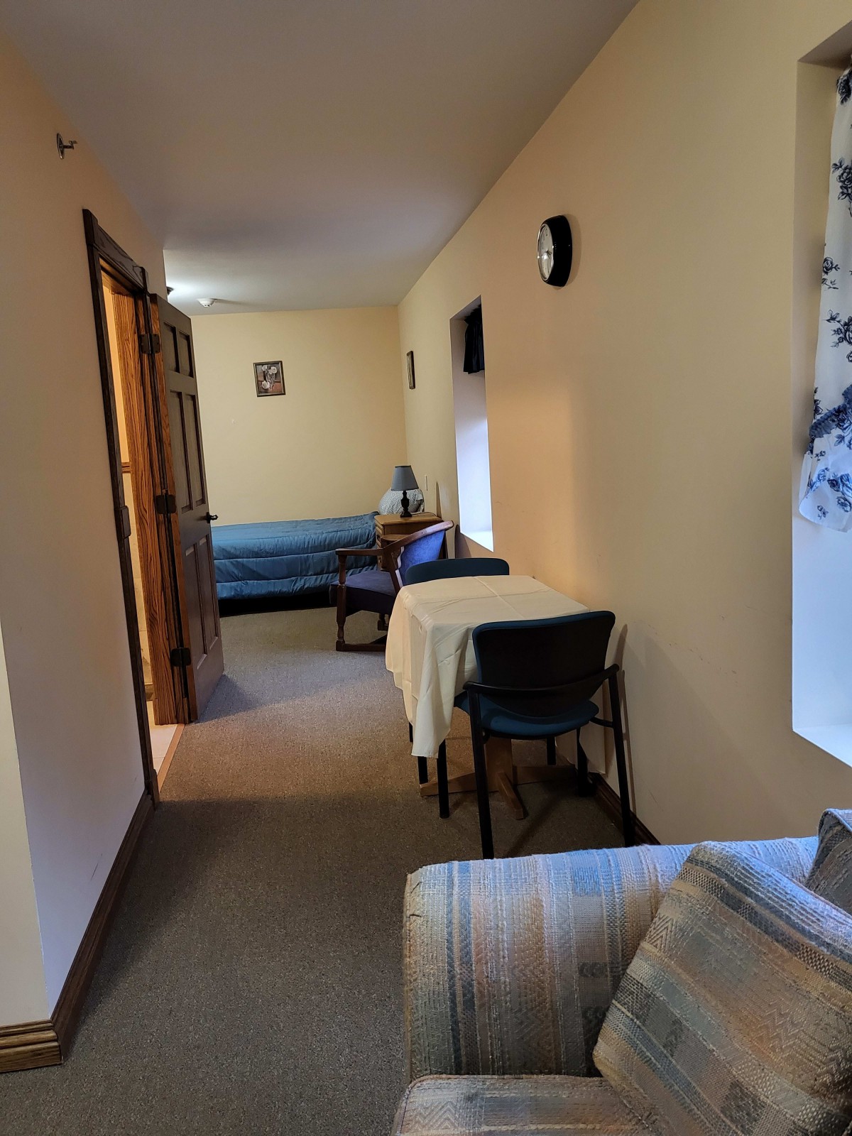 A cozy room with a table, chairs, and a bed.