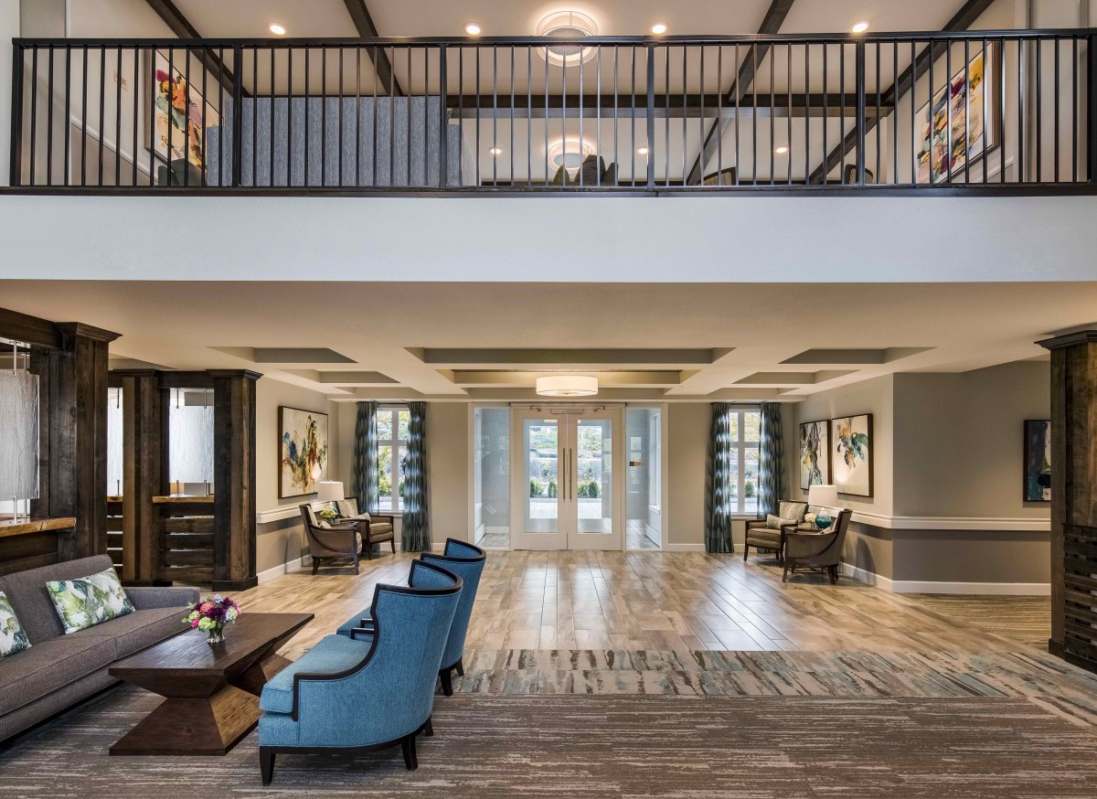 A modern and spacious lobby with elegant furniture and architectural design.