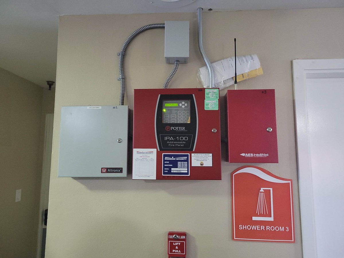 A wall-mounted fire alarm control panel setup for safety management.