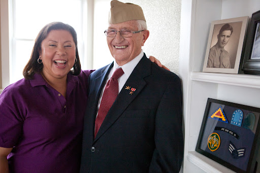 A joyful moment between a veteran and a friend, celebrating their bond.