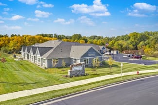 A suburban building with a well-maintained lawn and clear blue sky.