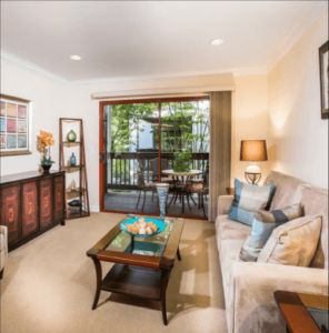 A cozy living room with elegant decor and a view of the balcony.