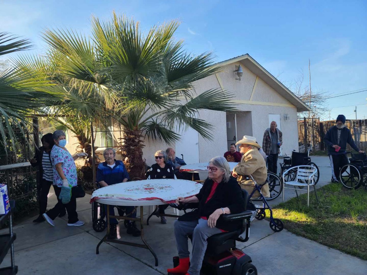 A group of seniors enjoying an outdoor gathering on a sunny day.