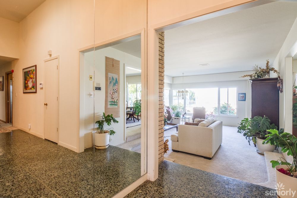 A modern living room with comfortable seating and ample natural light.