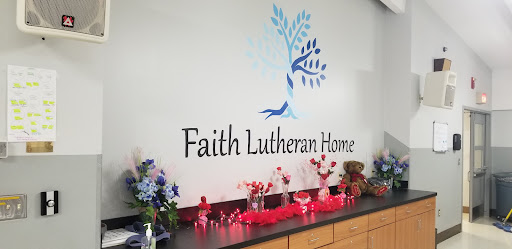 A beautifully decorated space at Faith Lutheran Home, featuring artistic wall design and vibrant floral arrangements.