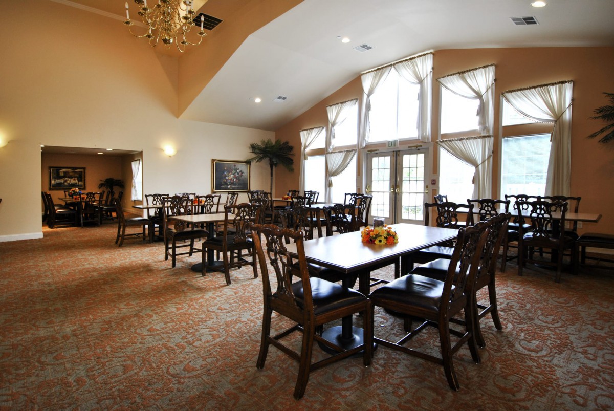 Spacious dining area with large windows and elegant furnishings.
