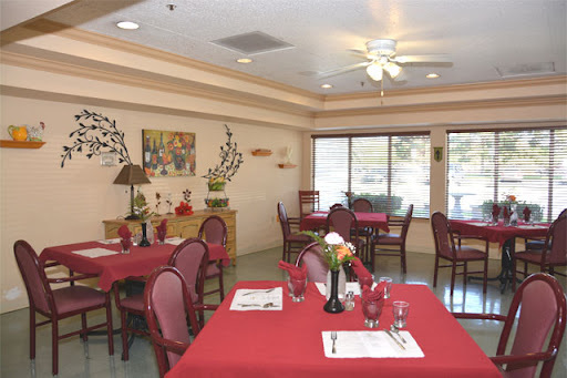 Cozy dining area with red tablecloths and floral centerpieces, perfect for a welcoming meal.