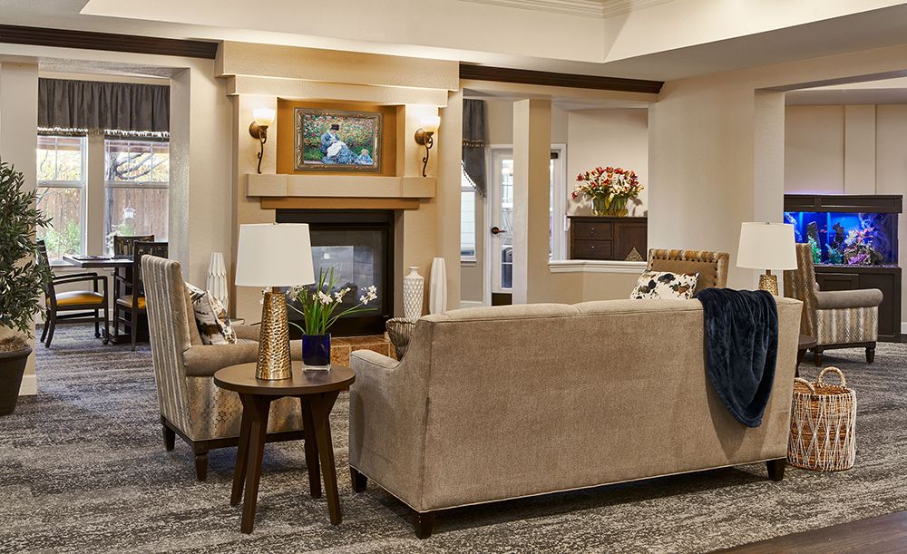 A cozy living room with a beige sofa, fireplace, and elegant decor.