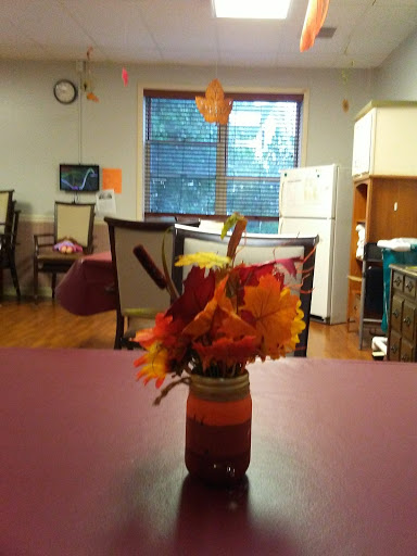A cozy indoor setting with a vibrant autumn flower arrangement on the table.