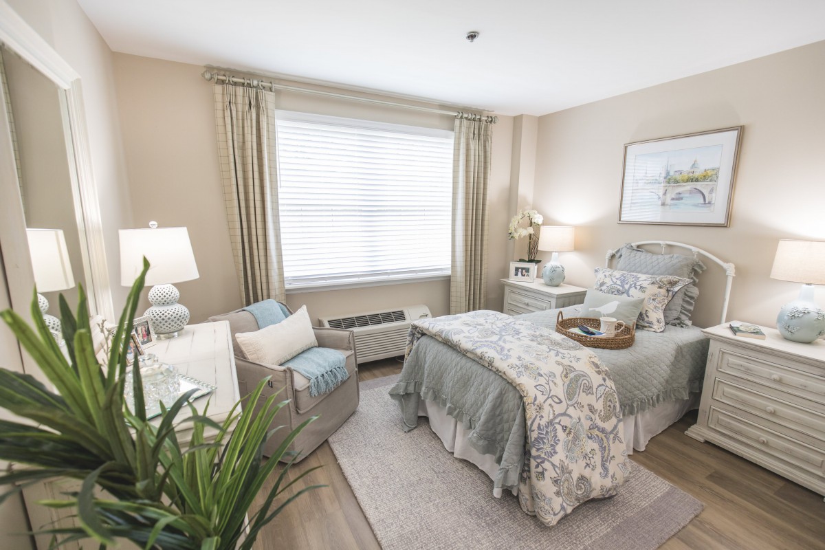 A cozy and elegantly decorated bedroom with neutral tones and stylish furnishings.