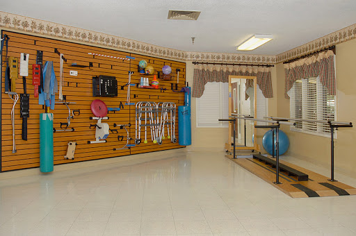 A well-equipped rehabilitation space featuring various therapy tools and exercise equipment.