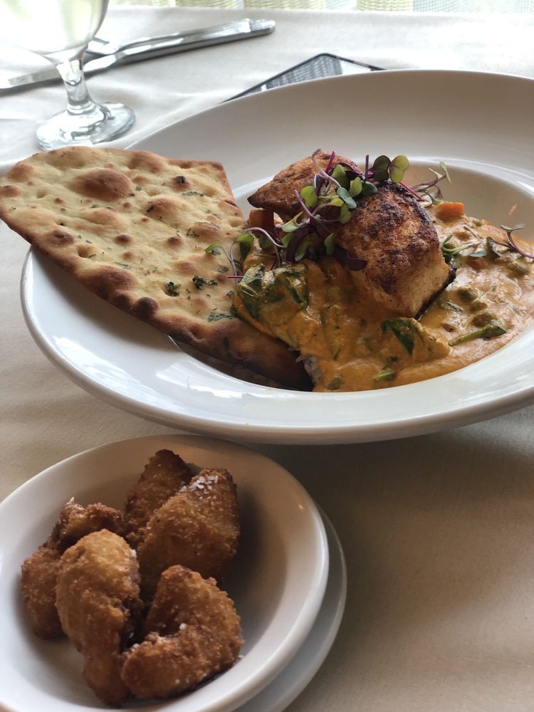 A delicious plate of pasta served with bread, accompanied by a side dish.