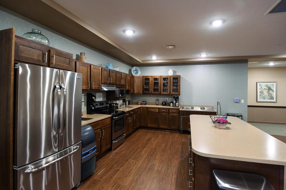 A modern kitchen with wooden cabinets and stainless steel appliances.