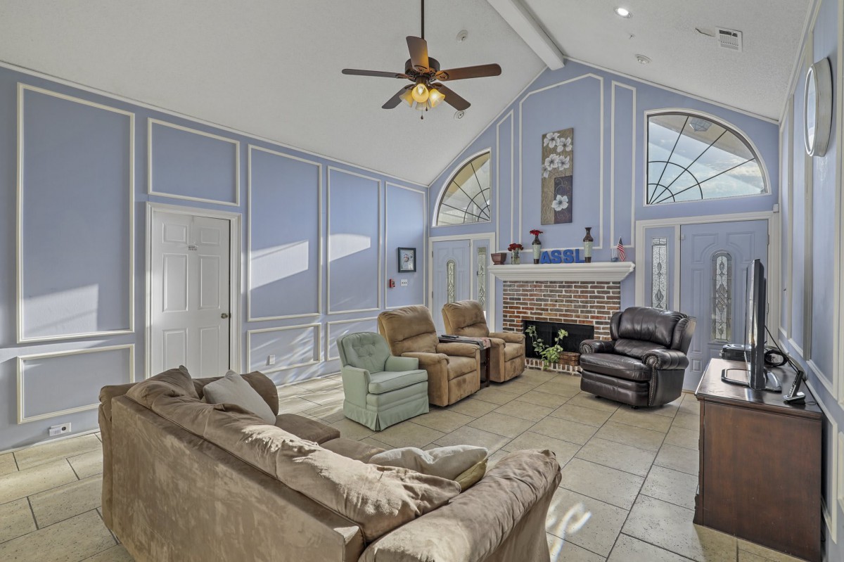 A spacious living room with comfortable seating and a fireplace.