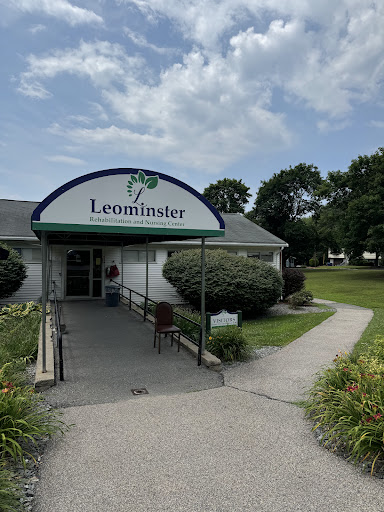 A welcoming view of the Leominster building, surrounded by well-maintained greenery and a clear sky.
