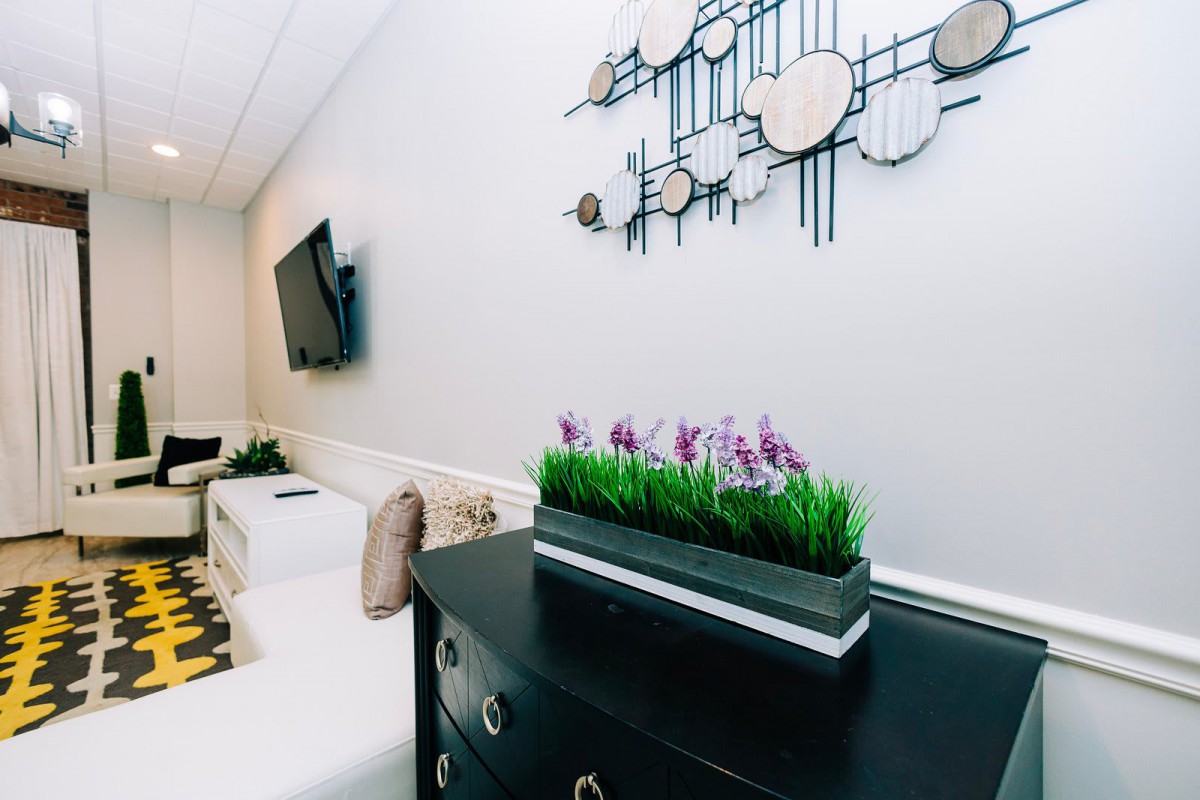 A modern living room with stylish wall art and indoor plants.