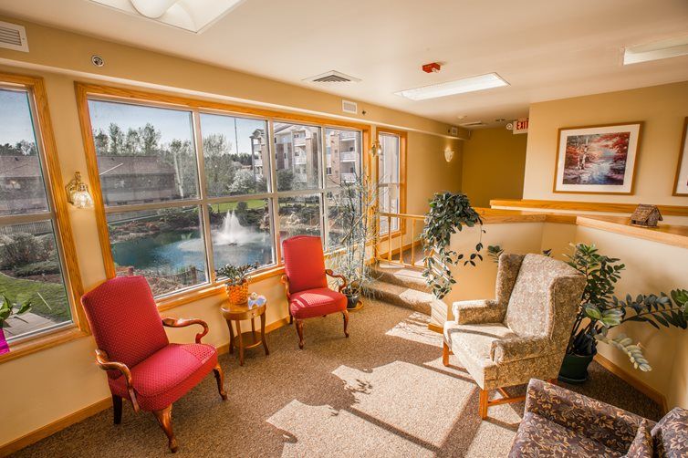 Bright lounge area with comfortable seating and large windows overlooking a scenic view.