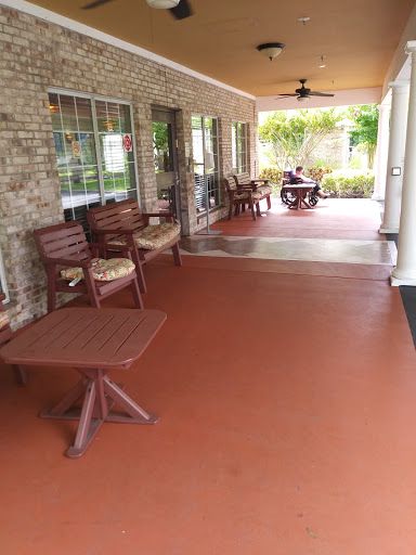 A cozy porch area with wooden furniture, perfect for relaxation.
