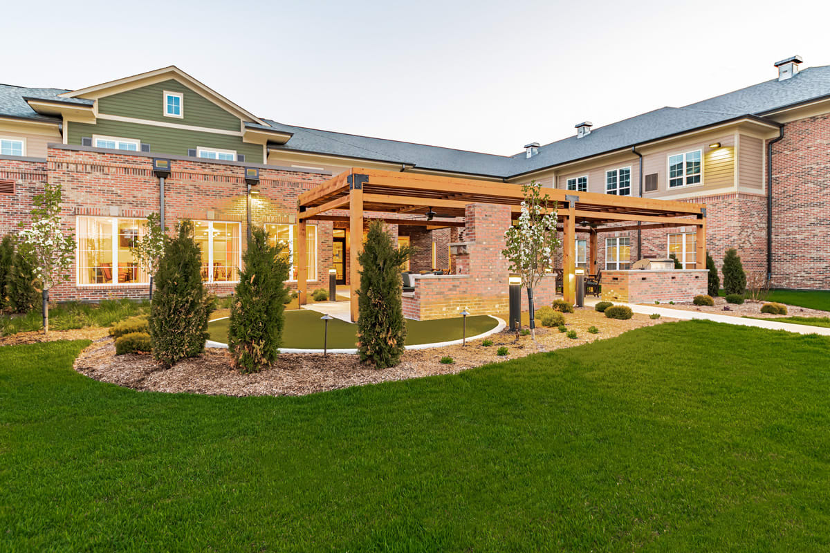 A modern residential home with a landscaped garden and outdoor living area.