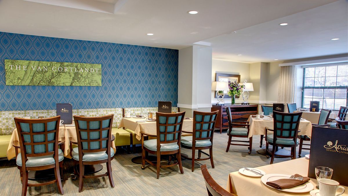 A cozy restaurant dining area with neatly arranged tables and chairs, featuring elegant interior design.