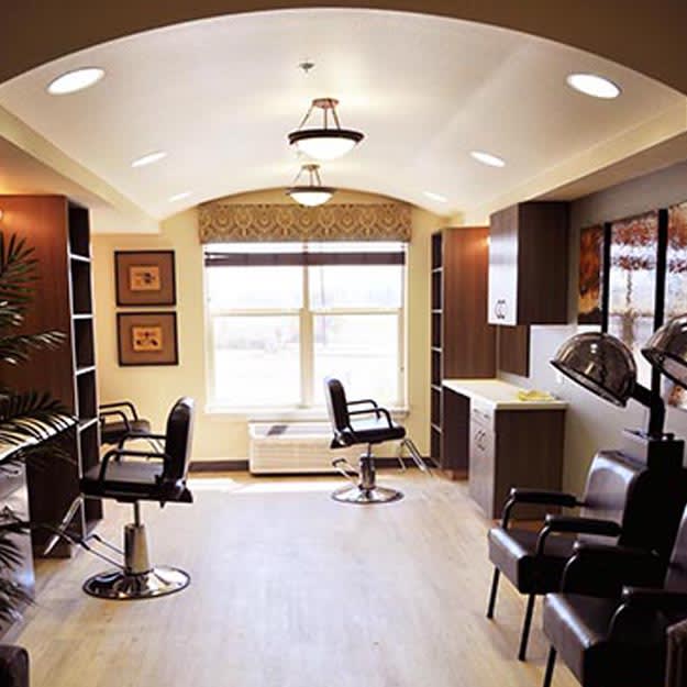 A well-lit hair salon interior with chairs and mirrors.