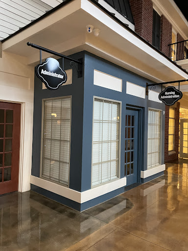 A stylish storefront with blue accents and large glass windows, located inside a modern mall.