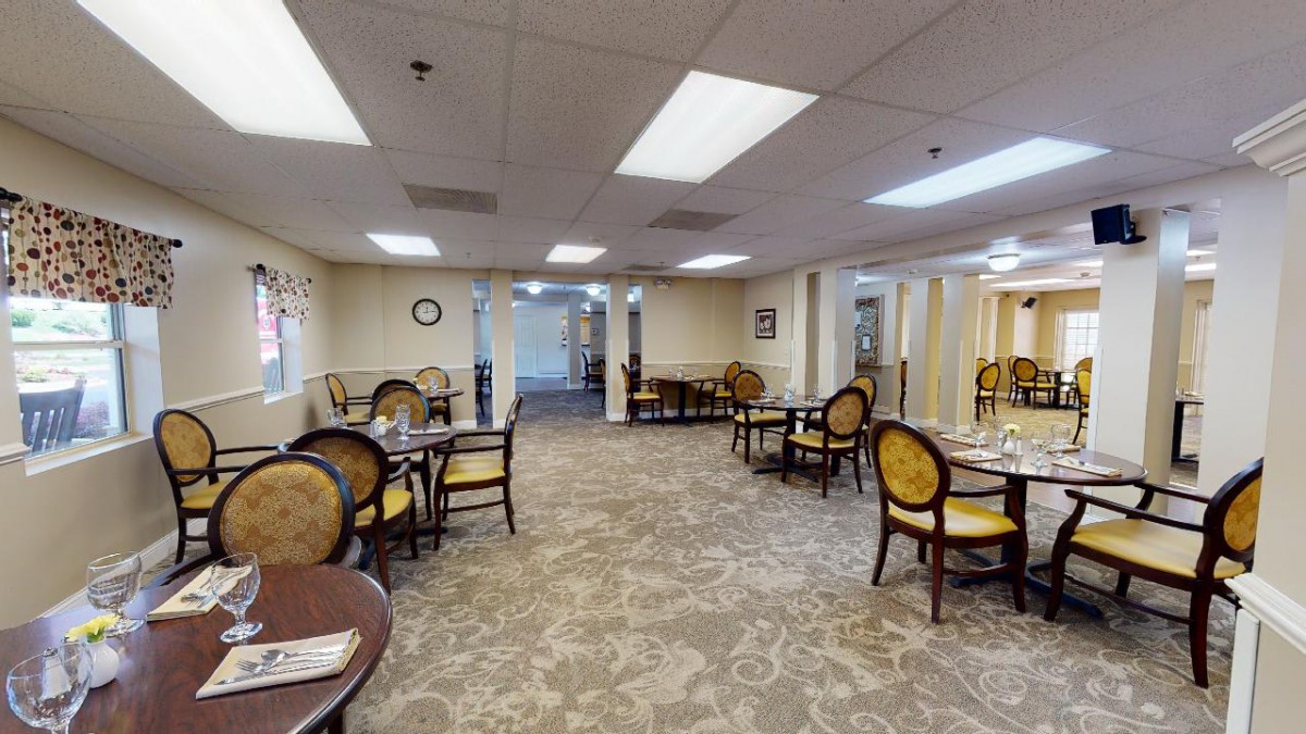 A spacious dining room with elegant seating and well-lit interior.