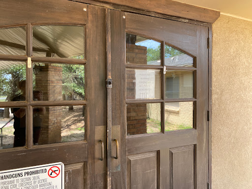 A wooden double door with glass panels, serving as an entrance.