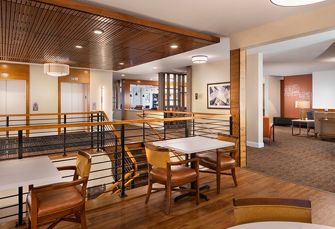 A modern restaurant interior featuring wooden furniture and stylish lighting.