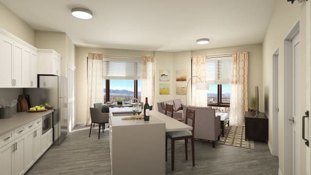 A modern open-concept living and dining area with a kitchen, featuring stylish furniture and large windows offering scenic views.