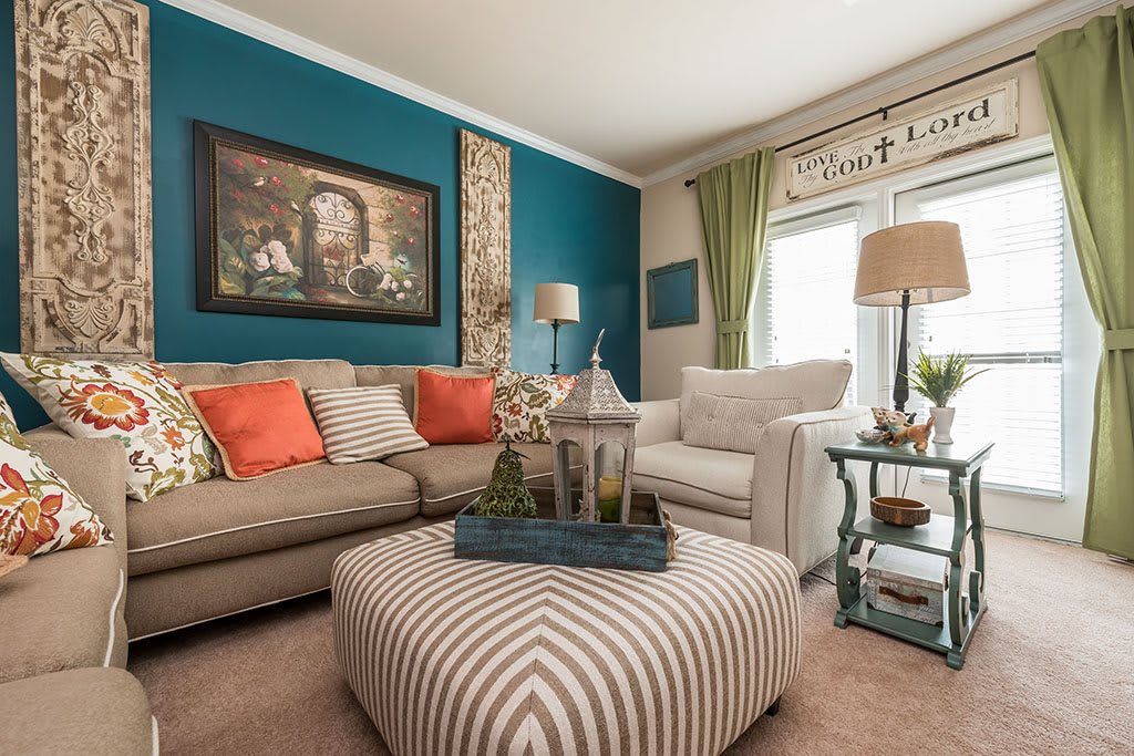 A cozy and stylish living room featuring a colorful palette with a striped ottoman as the focal point.