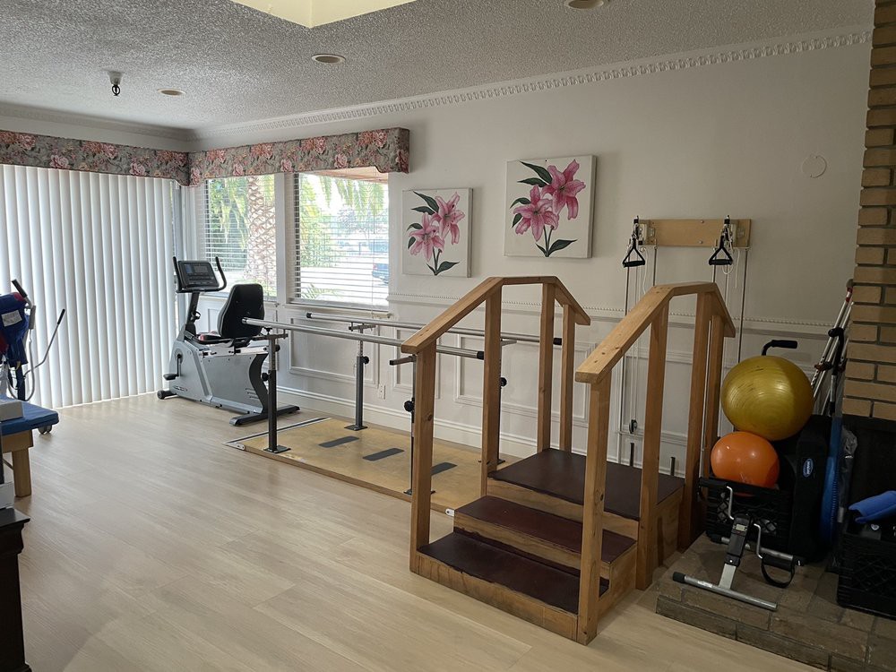 A rehabilitation room equipped with exercise equipment for physical therapy.