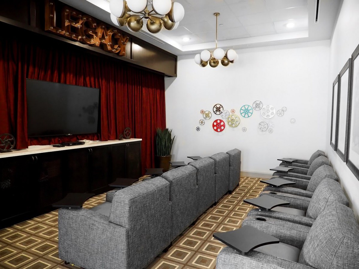 A modern home theater setup with comfortable seating and a large screen.