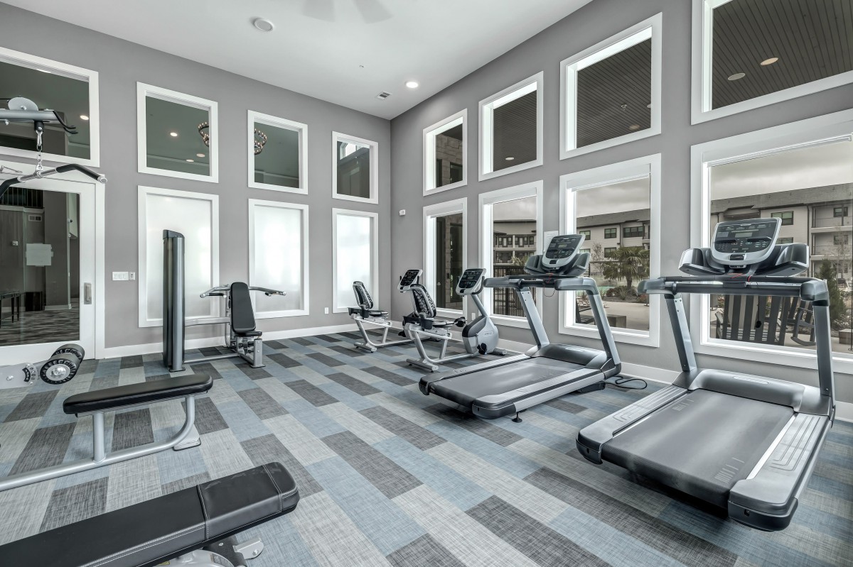 A modern gym with treadmills and exercise equipment in a well-lit space.