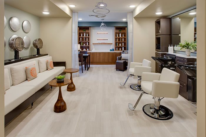 A modern salon with comfortable seating and stylish decor.