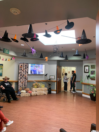 A festive community center decorated with Halloween hats and cheerful ambiance.