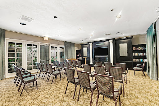 A spacious meeting room equipped with chairs arranged for a presentation.