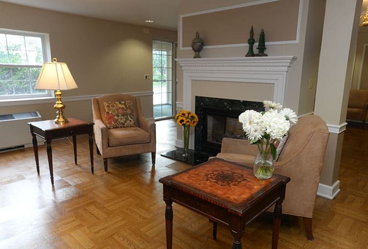 A cozy living room featuring a fireplace, comfortable seating, and elegant dcor.