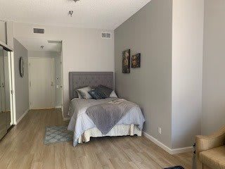 A modern bedroom with a minimalist design featuring a cozy bed and stylish decor.