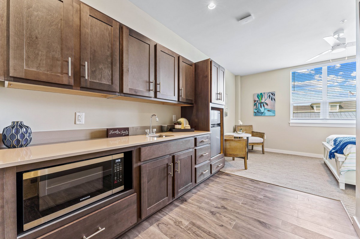 A modern kitchen with wooden cabinets and a cozy dining area.