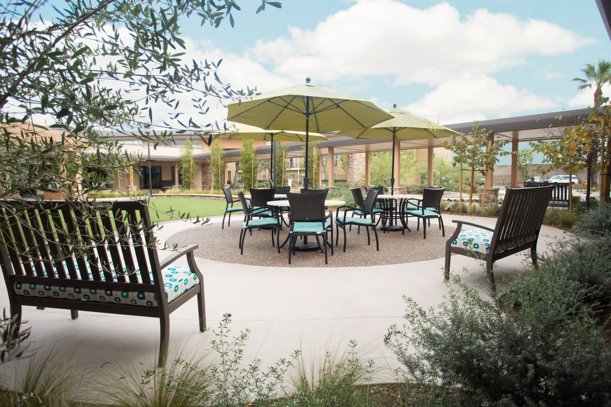 A scenic patio area with tables and chairs under umbrellas.