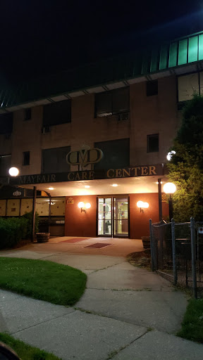 Entrance of a building illuminated at night.