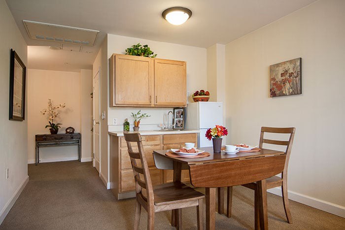 A cozy dining area in a kitchen with wooden furniture and modern decor.