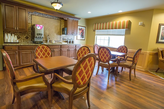A cozy dining area with wooden furniture and warm lighting.