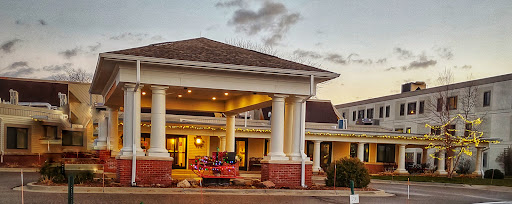 A beautifully designed hotel entrance at sunset, showcasing elegant architecture with columns.