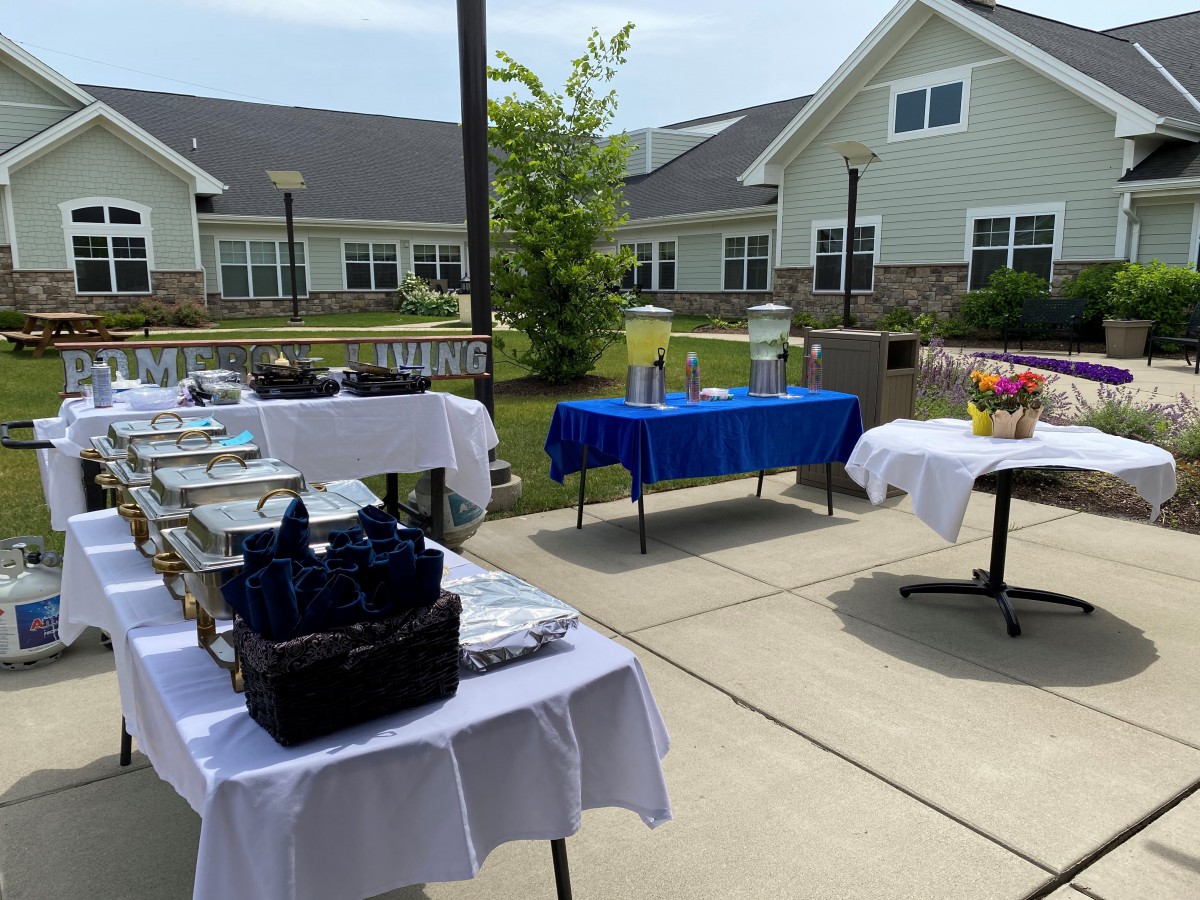Outdoor buffet setup with tables and catering equipment.